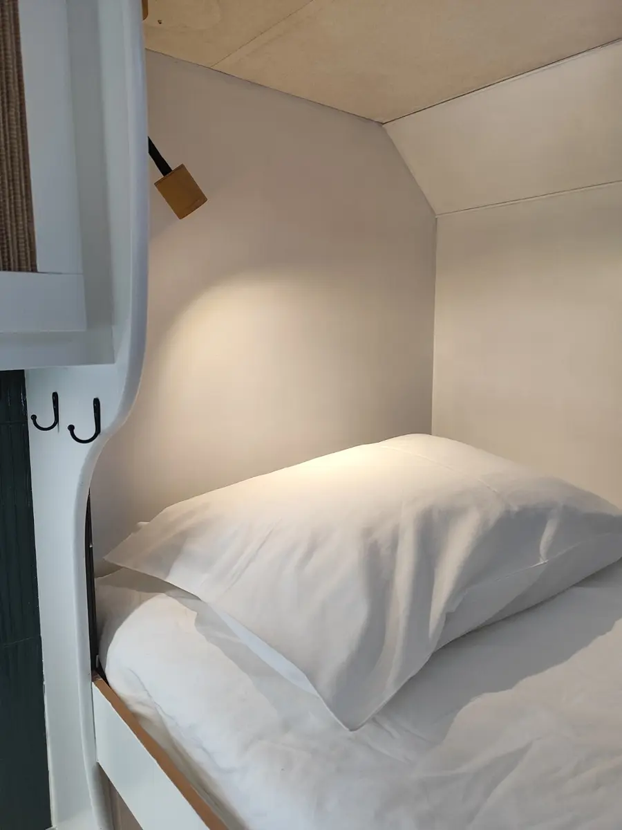Made-up bed with reading light